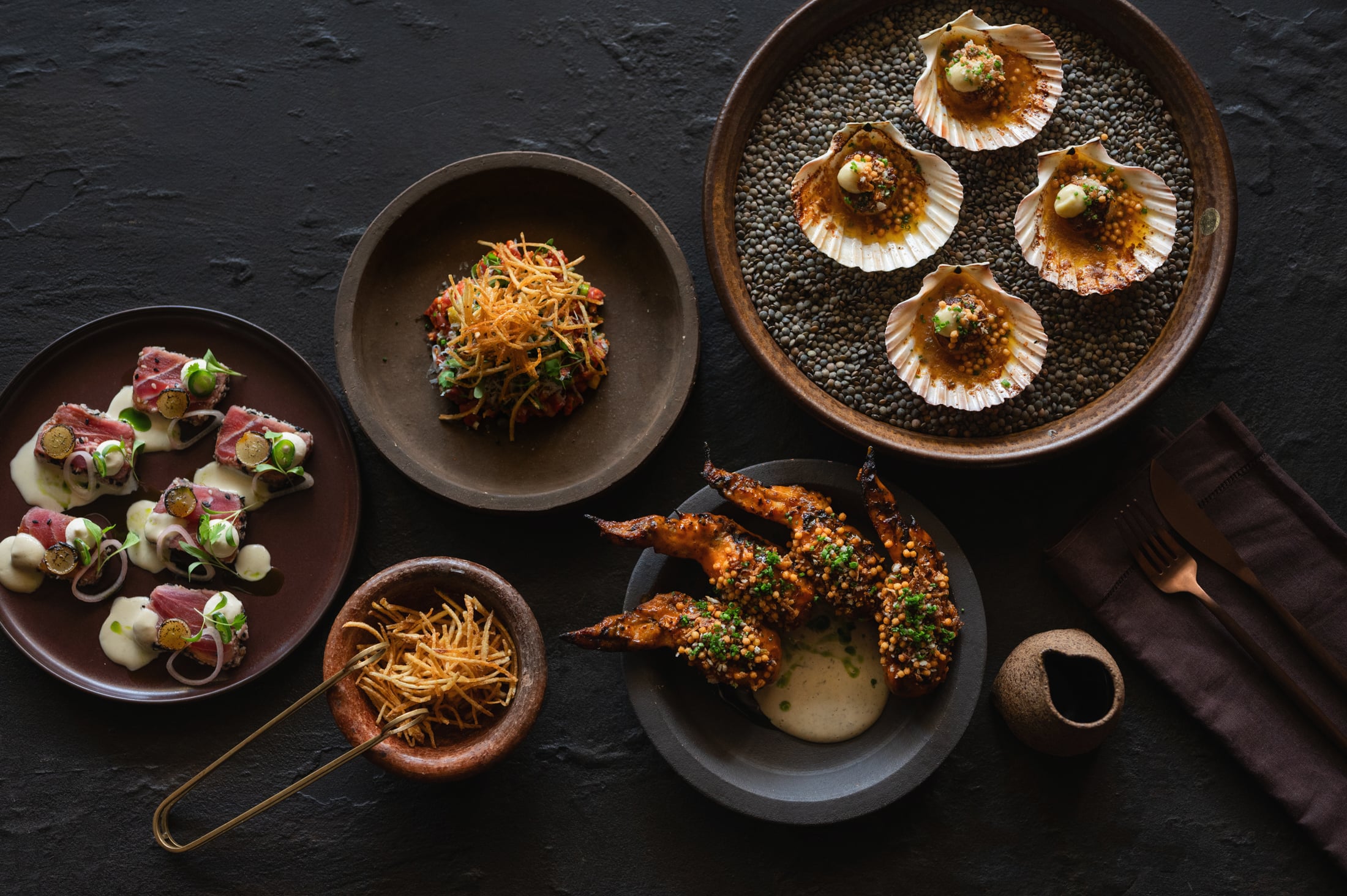 Four-part tasting plate with Szechuan calamari, bruschetta, pork belly and boerewors